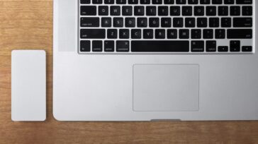 OWC Envoy Pro on a desk next to a MacBook Pro computer